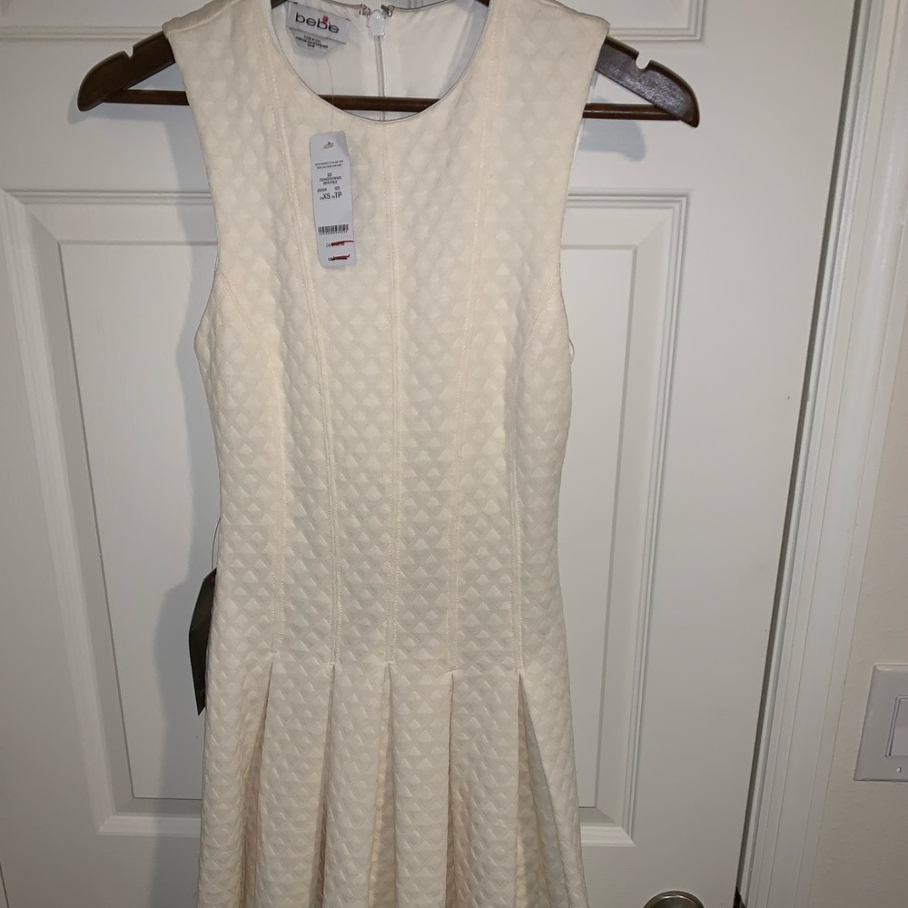 Off white Bebe dress with pleated skirt NWT XS